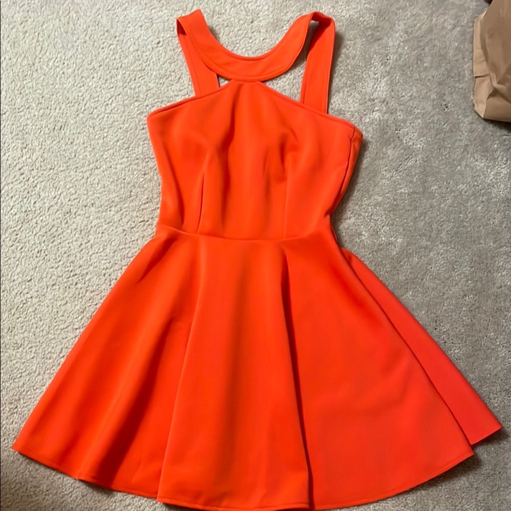 Super flattering vibrant orange dress with skater skirt, perfect for game day!